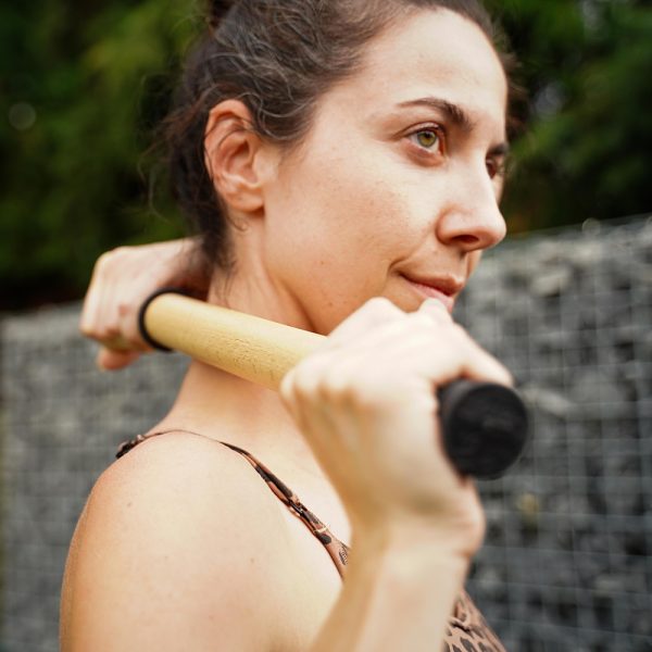 Woman Rolling her neck with ReGreen The Original 18" Wood Roller Massage Stick