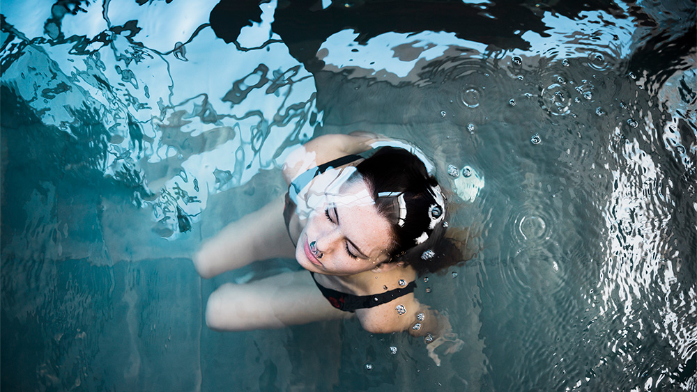 Woman submerging in cold water