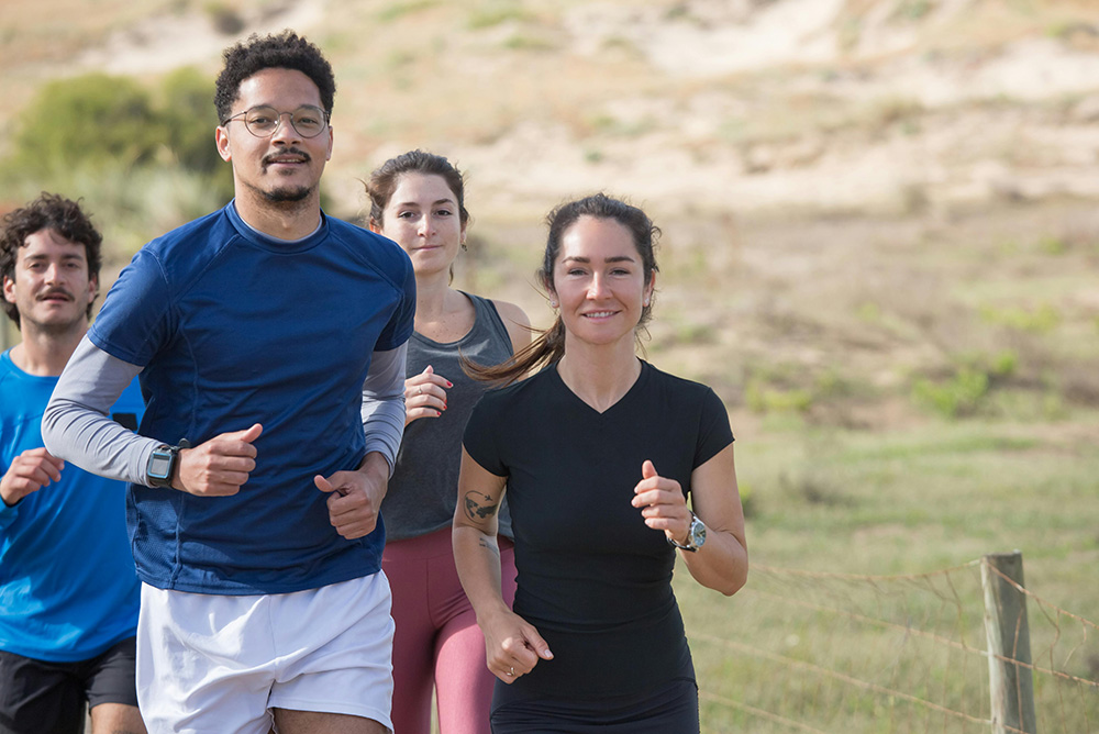 Group of man and woman jogging and exercising together