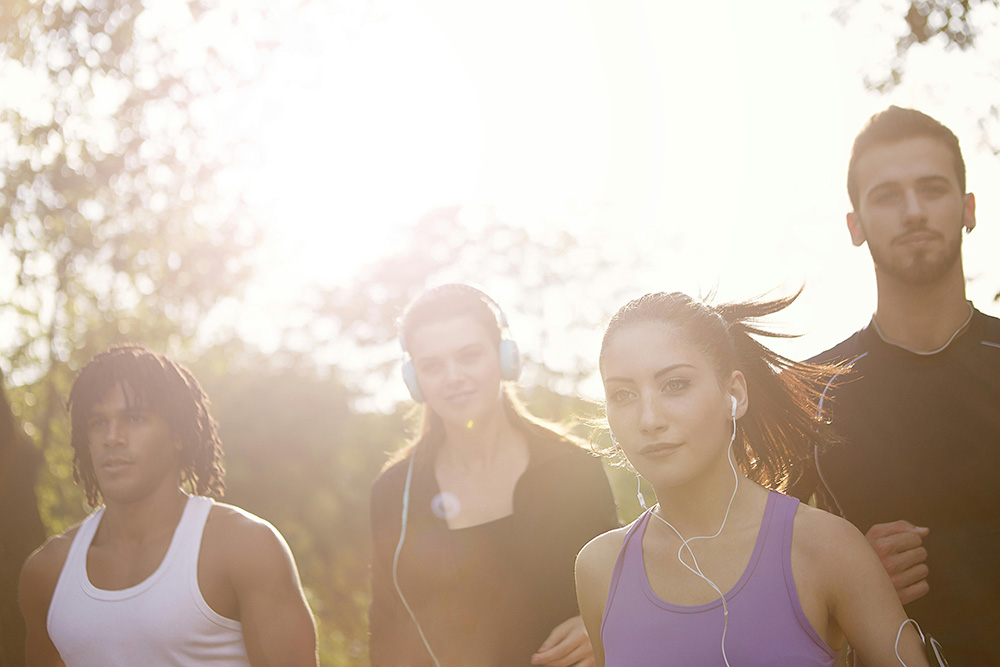 Happy diverse sports people jogging in park