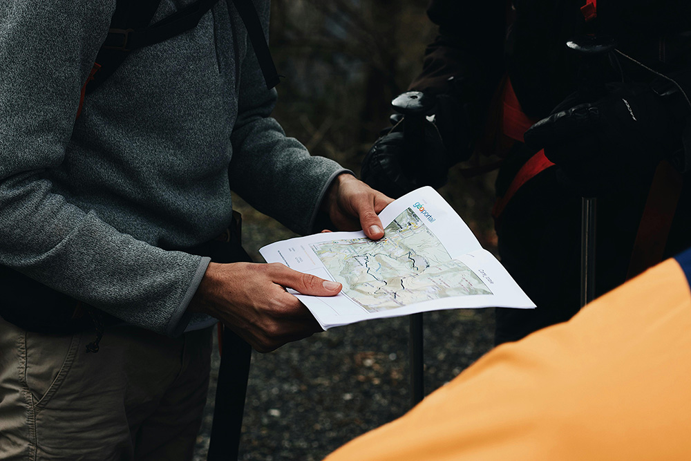 Person Looking At A Map in the middle of a hiking trip