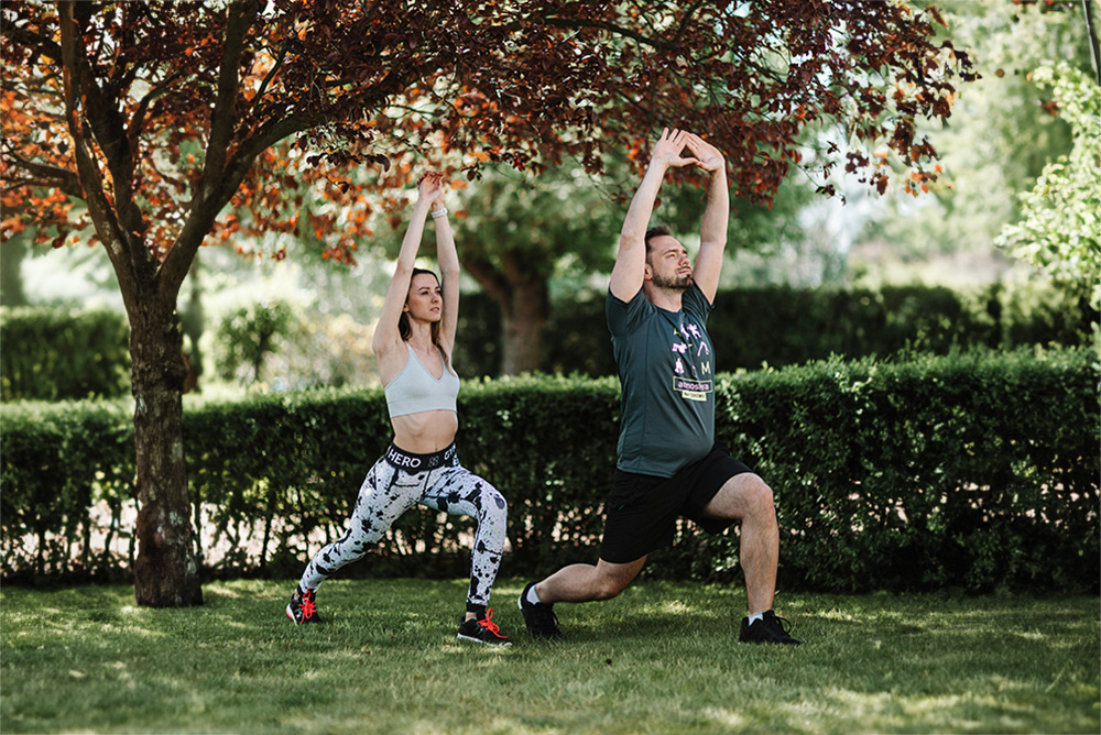 Man and woman warming up before exercise in fall weather