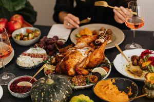 Thanksgiving dinner with roasted turkey, sweet potatoes, cranberries