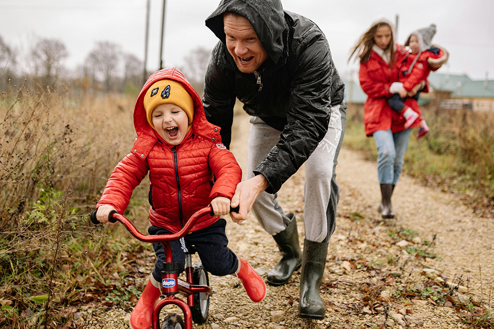 Family time Father Teaching His Son How to Ride a Bike