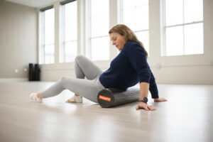 A person using the Tiger Tail Foam Roller to roll out muscle knots in back, glutes and a knot in calf muscle. The massage stick and the Tiger Ball can target deep knots in shoulders.